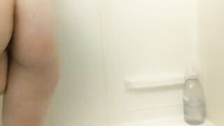 Short-haired emo girl uses a huge dildo and showerhead to masturbate