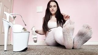 Wearing sexy white tights and pleasers, this babe indulges in foot worship