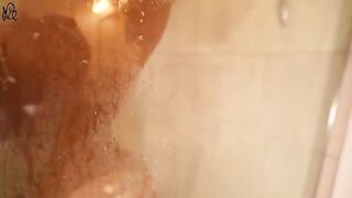 A pretty girl has sex with a big dildo in the shower, showcasing her tight pussy in action