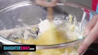 Two stepdaughters are busy in the kitchen, engaged in some playful banter