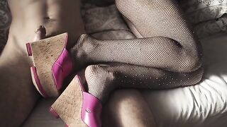 A sexy girl shows off her sexy legs in high heels and pantyhose