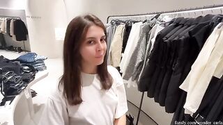 A girl is having fun with her boyfriend in the fitting room at the mall