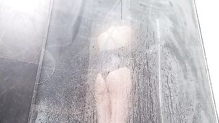 A woman rubs her clitoris until she squirts in the shower