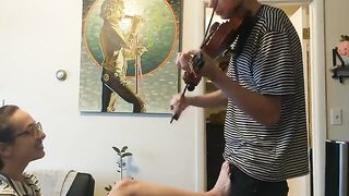 Passionate violin practice interrupted by eager girlfriend