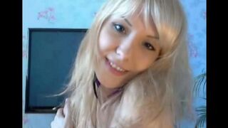 A blonde with small boobs caresses her pussy
