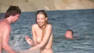 A hot mature woman is walking naked on the beach and playing with her body