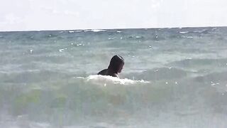Two girls are basking in the sun naked on the beach
