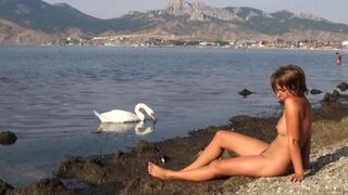 Nude beauty has sex on the riverbank