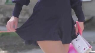 A very beautiful girl removes her clothes, showcasing her stunning look