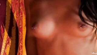 A girl with a clitoris piercing plays with her nipples and pussy