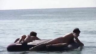 A naked woman is having fun on the beach with her companion