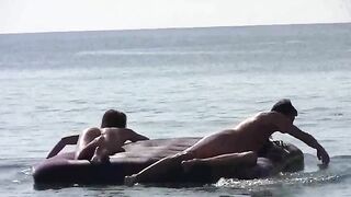 A naked woman is having fun on the beach with her companion