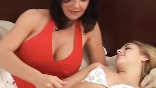 A young woman is having fun with her older girlfriend using a strap-on