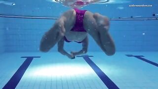 A naked woman is swimming in the pool, creating a sexy splash