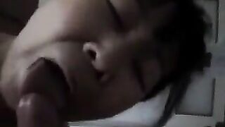 A Chinese woman practices her blowjob skills on him in bed