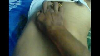 The husband massages her nipples to make her moan with pleasure