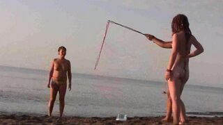 A young couple have fun on the beach without any clothes