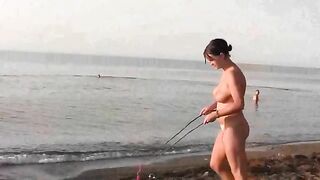 A young couple have fun on the beach without any clothes