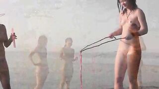 A young couple have fun on the beach without any clothes
