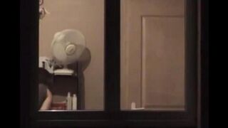 The guy looks at himself in the mirror, not dressed