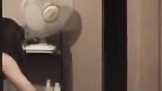 The guy looks at himself in the mirror, not dressed