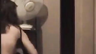 The guy looks at himself in the mirror, not dressed