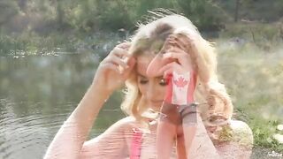A blonde is masturbating gently by the lake, her body trembling with pleasure