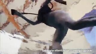 A sexy girl is floating naked in the pool. It's very erotic!