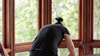 A cute girl was fucked by her girlfriend in the kitchen with a strap-on