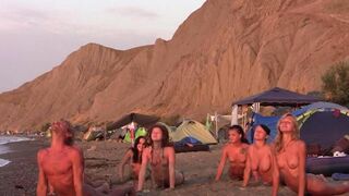 Nude beauties play volleyball without any clothes on the beach
