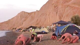 Nude beauties play volleyball without any clothes on the beach