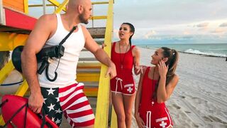 Two young lifeguards are having fun with one dick