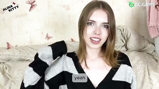 Almost naked, the girl is playing with her clothes, teasing