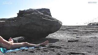 A girl undresses on the beach and rubs herself, exciting a guy