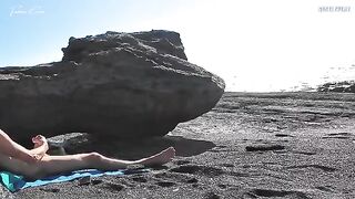 A girl undresses on the beach and rubs herself, exciting a guy