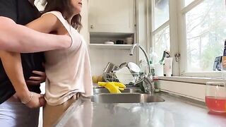A sexy brunette with big tits fucks her husband in the kitchen